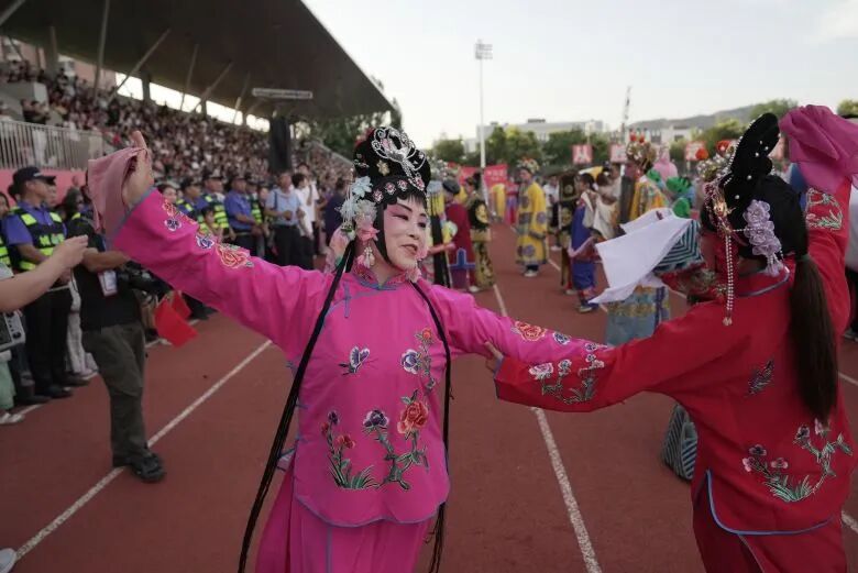 Performers dance ahead of kickoff at the Fuping county Village Super League final. Steve Wang/CNN